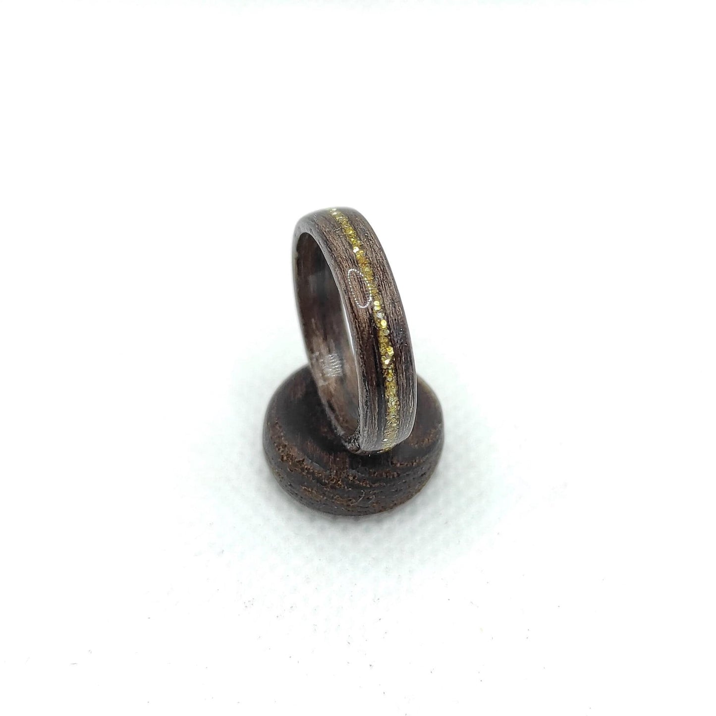 Close-up of bentwood walnut ring showing gold inlay detail