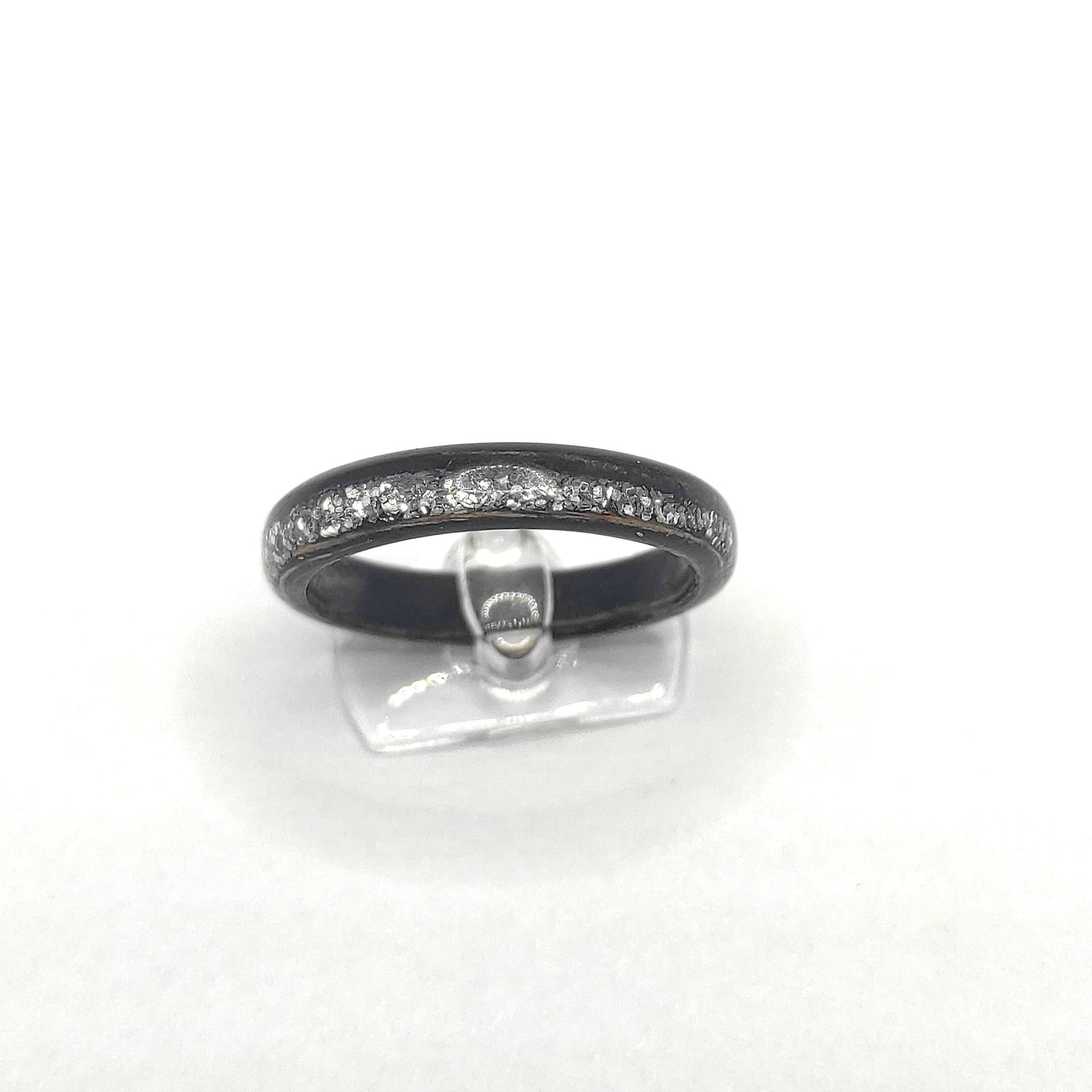 Side profile of eco-friendly ebony wooden ring with shimmering silver inlay”