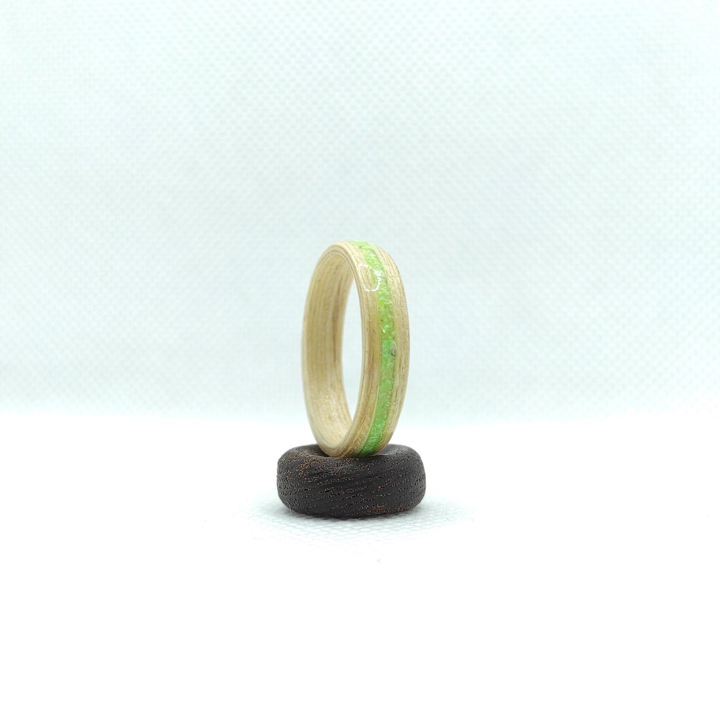 Nature-inspired birch wood ring featuring bright green sparkle

