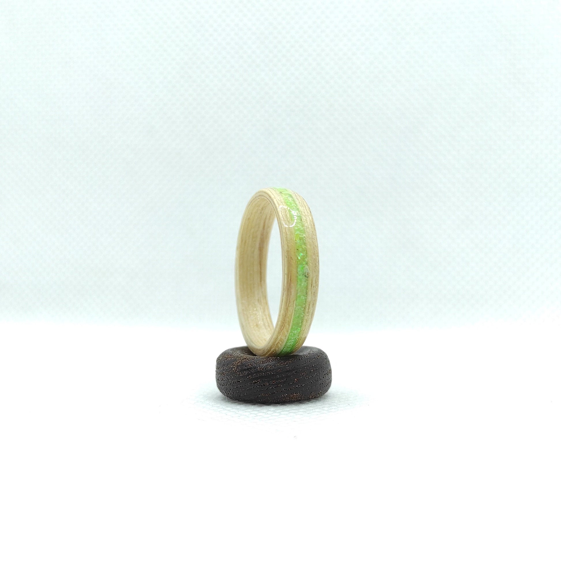 Nature-inspired birch wood ring featuring bright green sparkle

