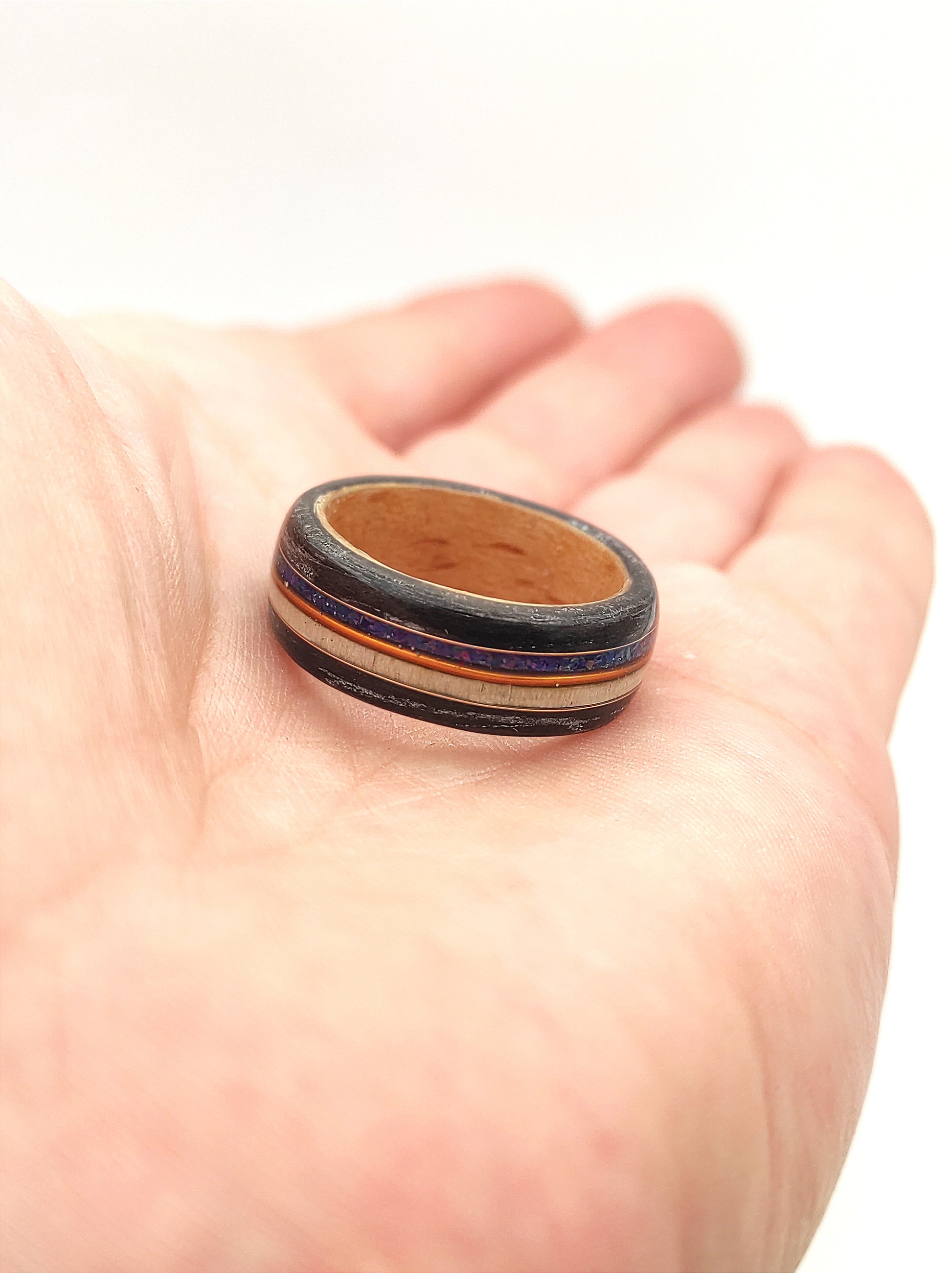Men’s wooden wedding band with black oak and shimmering blue opal inlay